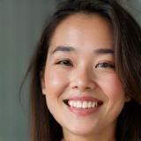 Photo of client Aisha looking pleased